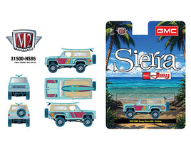 M2 Machines 1:64 1975 GMC Jimmy Sierra 4×4 Custom w/ Surfboard – Turquoise – Hobby Exclusive